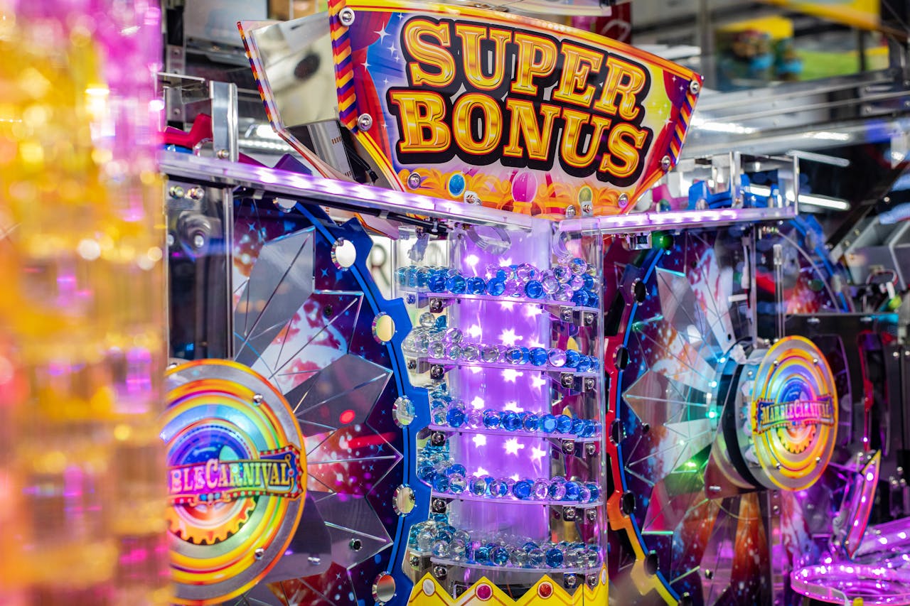 hero-img-01 Colorful neon arcade machine featuring a 'Super Bonus' display with bright lights and playful design.
